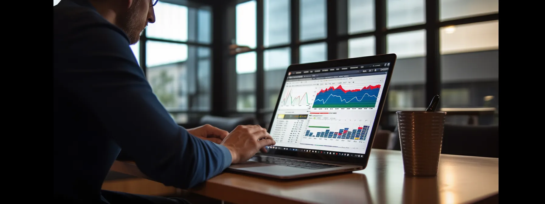 a person sitting at a desk with a laptop, checking their website's search rankings and traffic analytics.
